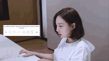 a woman is sitting at a desk using a computer mouse with circles around her head