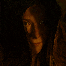 a close up of a woman 's face with a hood on her head