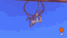 a basketball hoop against a blue sky with a hand pointing at it