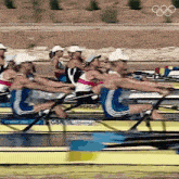 a group of people are rowing in a boat that says gbr on the side