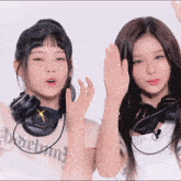 two girls wearing headphones and a shirt that says " hollywood "