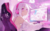 a girl wearing headphones is sitting in front of a computer monitor