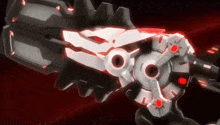 a close up of a robot 's arm with a red light coming out of it 's mouth .