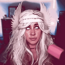 a woman wearing a headband with wings and blindfolds