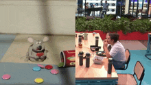 a woman sits at a table next to a can of gn