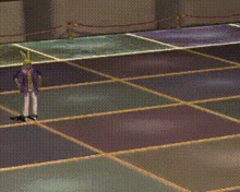 a person in a purple shirt is standing on a tiled floor