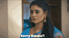 a woman in a blue saree says sorry amma !
