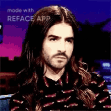 a man with long hair and a beard is making a funny face .