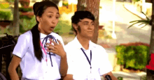 a boy and a girl are standing next to each other and the girl has her mouth open