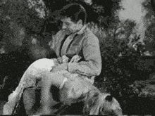 a man is carrying a woman on his back .