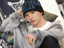 a person wearing a beanie that says " ether big d "