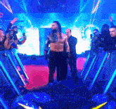 a man without a shirt walks through a tunnel of lights
