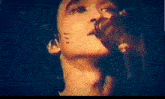 a close up of a person singing into a microphone