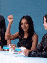 a woman sitting at a table with a cup that says zte
