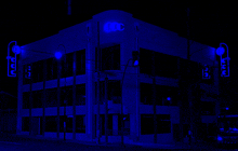 a building with a blue light on it that says uc