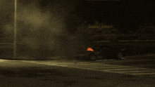 a car is on fire in front of a sign that says golden estrich