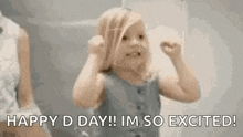 a little girl is dancing with her hands in the air and saying `` happy d day ! i 'm so excited ! ''