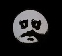 a hand is pointing a gun at a smiley face with a mustache