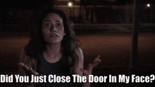 a woman is standing in front of a sign that says " did you just close the door in my face ? "