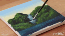 a painting of a waterfall is being painted on a canvas by chloe art