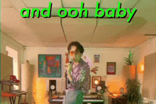 a man singing into a microphone with the words and ooh baby below him