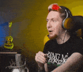 a man wearing headphones and a t-shirt that says ring of fire on it