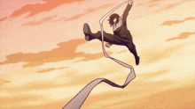a person is doing a handstand in the air with a ribbon around their neck