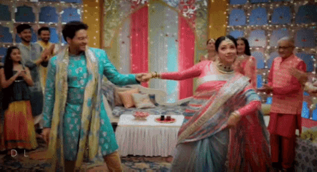 a bride and groom are dancing in front of a crowd with the letters dl on the bottom left 