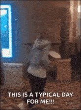 a woman is dancing in a room with the words `` this is a typical day for me '' .