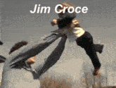 a man is kicking another man in the air with the name jim croce written on the bottom