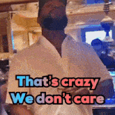 a man with a beard stands in front of a sign that says that 's crazy we don 't care