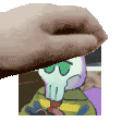 a hand is holding a picture of a squidward tentacles from spongebob squarepants .