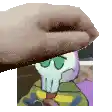 a hand is holding a picture of a squidward tentacles from spongebob squarepants .