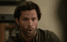 a man with a beard makes a surprised face
