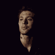 a man with a bandage on his neck is smiling