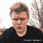 a young man wearing a black shirt that says " minimx " on it