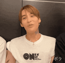 a man wearing a white t-shirt that says " one " on it