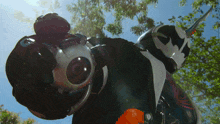 a person in a black and white costume with a camera on their hand