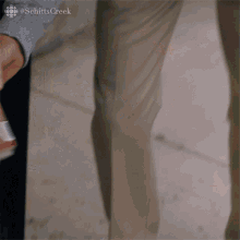 a man is opening a soda can with his hands .