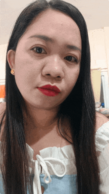 a woman with long black hair and red lipstick