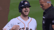 a baseball player wearing a helmet and a shirt that says astros