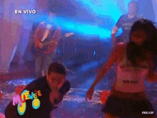 a group of people are dancing in front of a sign that says muevee on it
