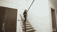 a woman is walking down a set of stairs made by animatica