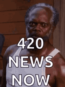 a man with a beard is wearing a white tank top with the words 420 news now on it .