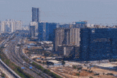an aerial view of a city with a large building that says ' axis ' on the side