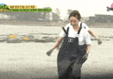 a woman wearing overalls with a name tag that says " su "