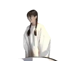 a woman with braids is wearing a white sweater and dancing