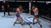 two women are fighting in a boxing ring sponsored by jeremy 's razors and bud light