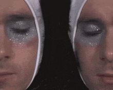 a close up of two people 's faces with makeup on them