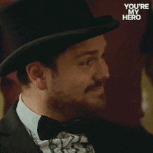 a man wearing a top hat and bow tie with the words you 're my hero below him